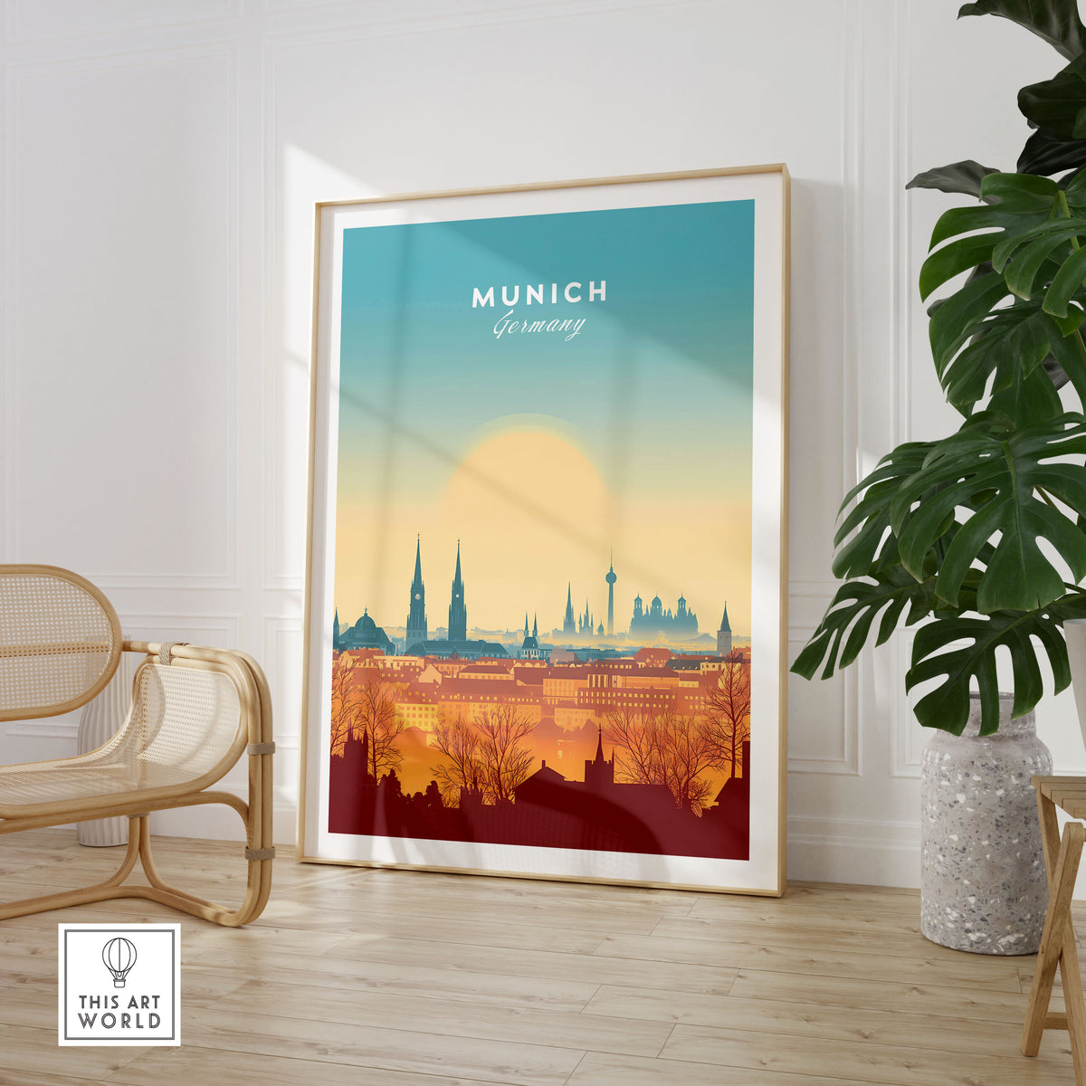 Munich Wall Art in a large natural wood frame leaning in a room with a rattan chair and monstera plant