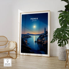 Paros Greece Print in a large natural wood frame leaning in a room with a rattan chair and monstera plant