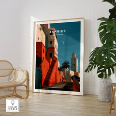 Tangier Morocco Kasbah Steps Travel Poster — coral kasbah steps climbing towards a minaret under a crescent moon, shown as large framed print room setting chair plant