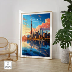 Toronto Poster in a large natural wood frame leaning in a room with a rattan chair and monstera plant