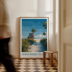 Framed Anna Maria Island Florida travel poster with beach scene on floor, man walking past