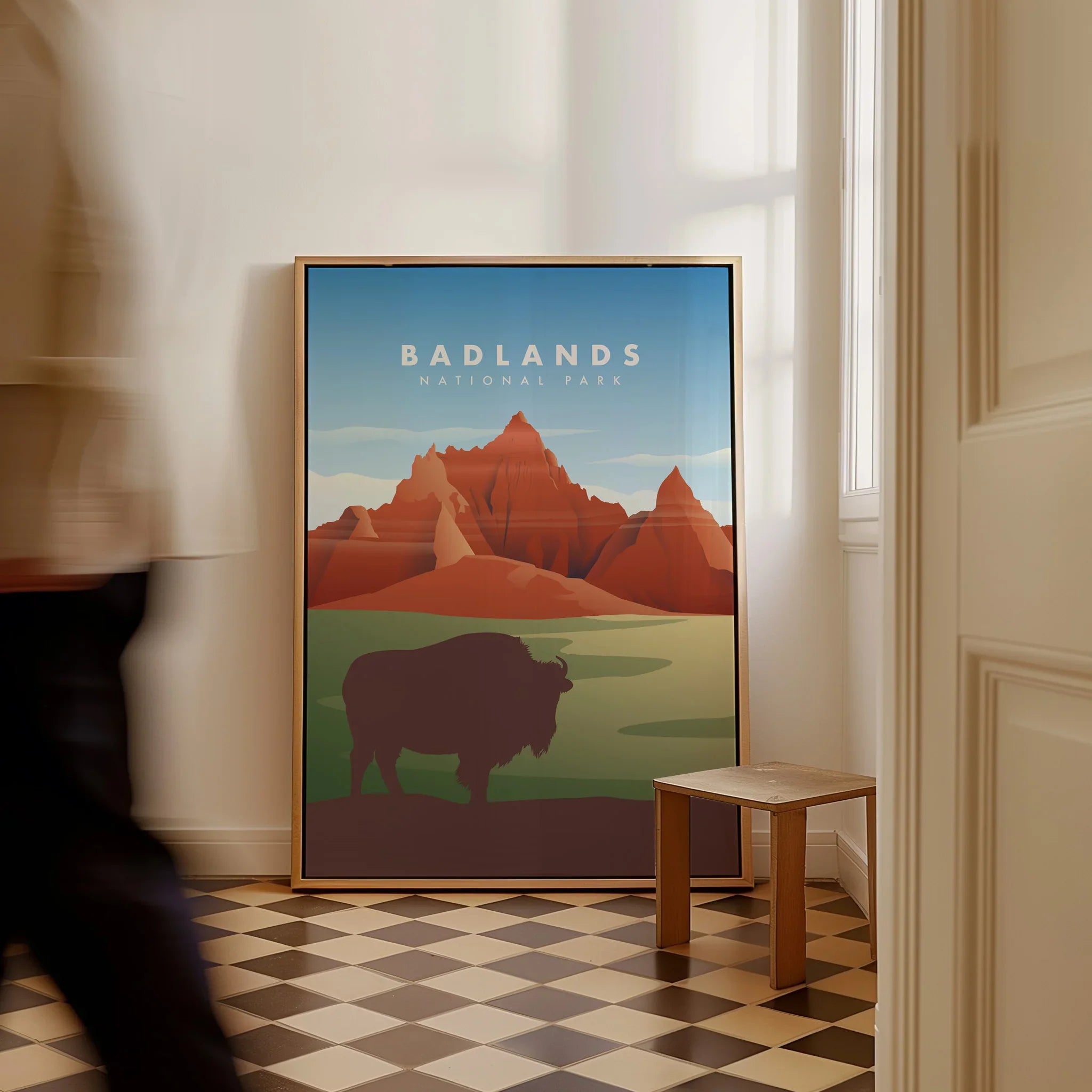 Framed Badlands National Park art print with bison and mountains, leaning on floor