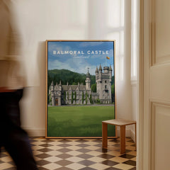Framed Balmoral Castle Scotland travel poster leaning on wall in modern home interior