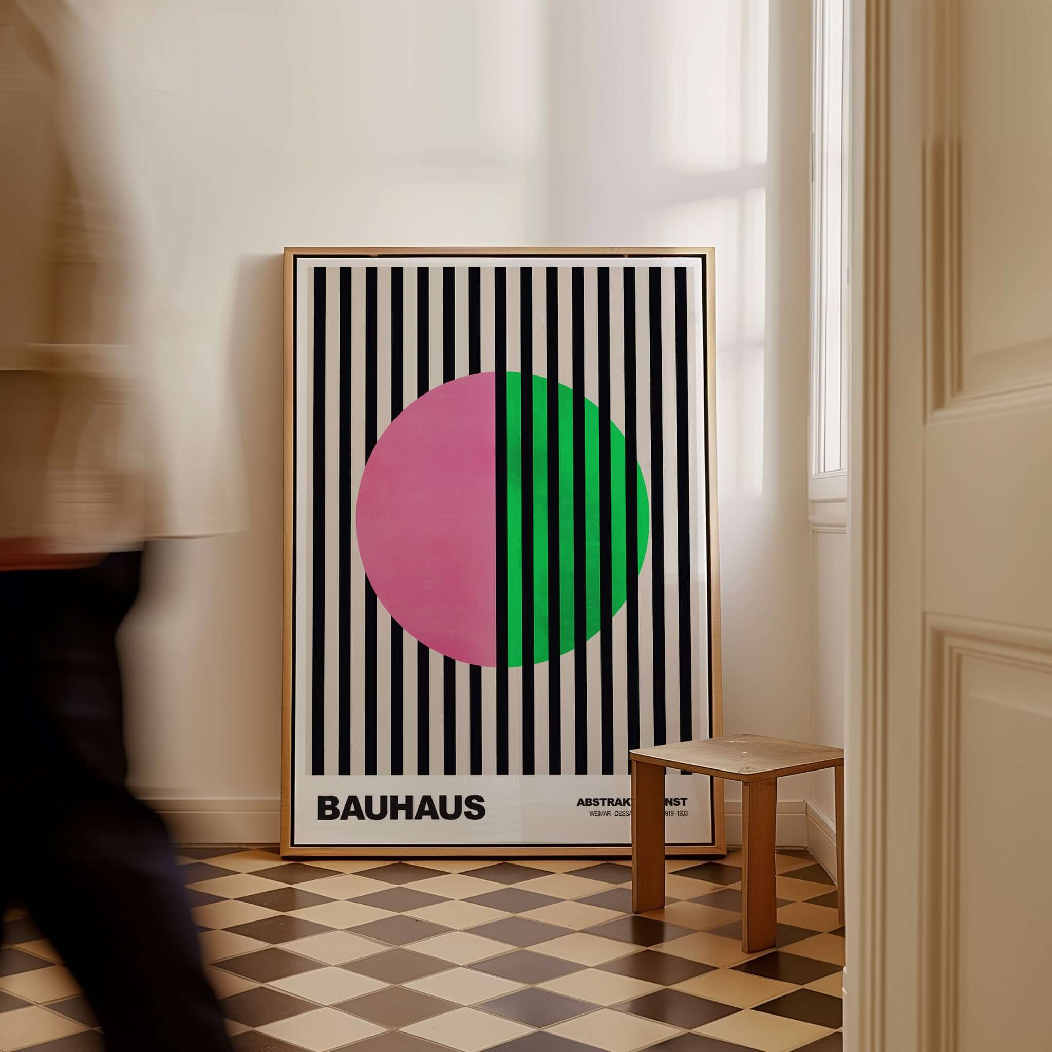 Bauhaus Exhibition Prints - Split Circle Abstract Art Print Pink Green Stripes displayed in a stylish interior with striped background.