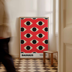 Bauhaus Exhibition Prints - Repeating Eyes Pattern Poster Red Black Cream Art displayed in a stylish interior setting.