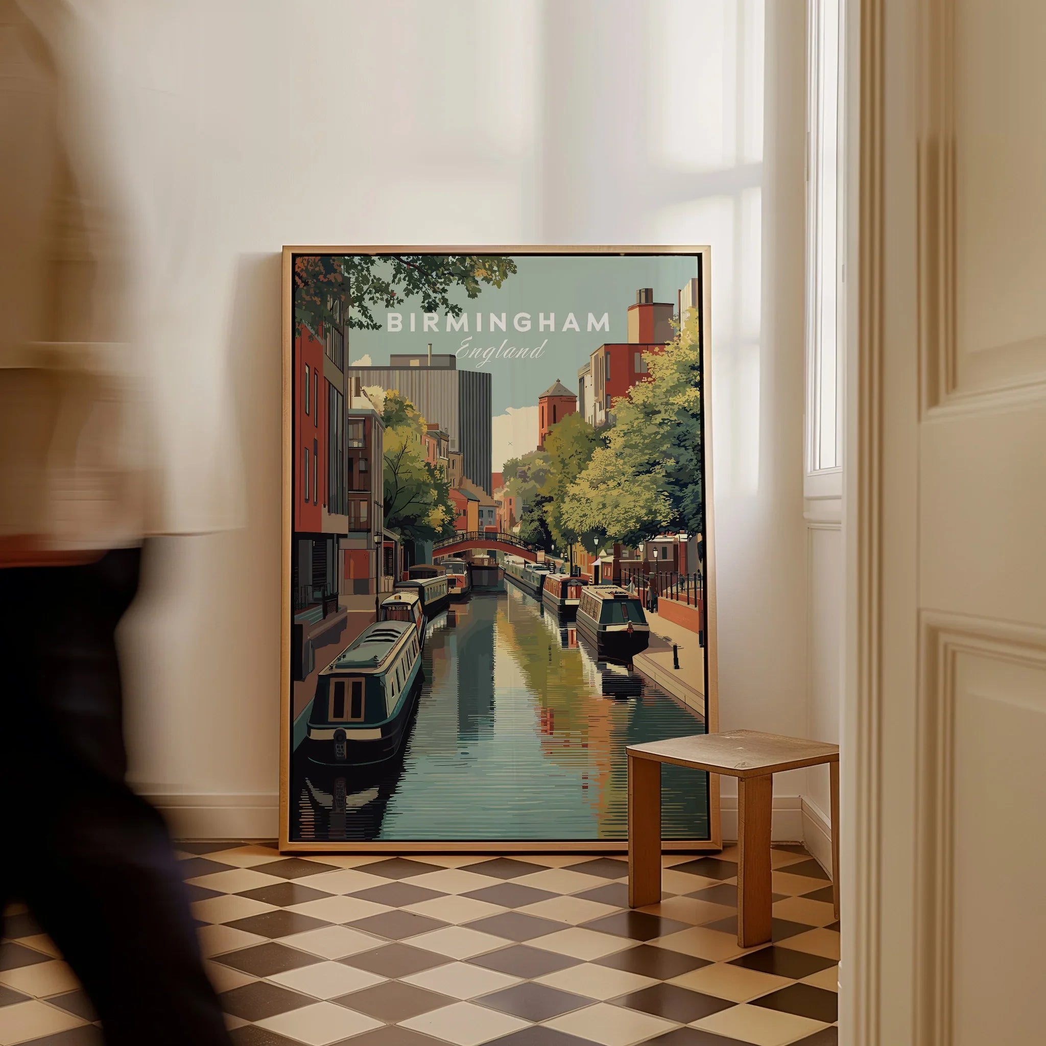 Framed Birmingham England travel poster on floor, canal scene, man walking past, modern decor
