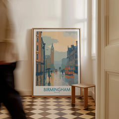 Framed Birmingham city art print on floor in modern home entryway, person walking by