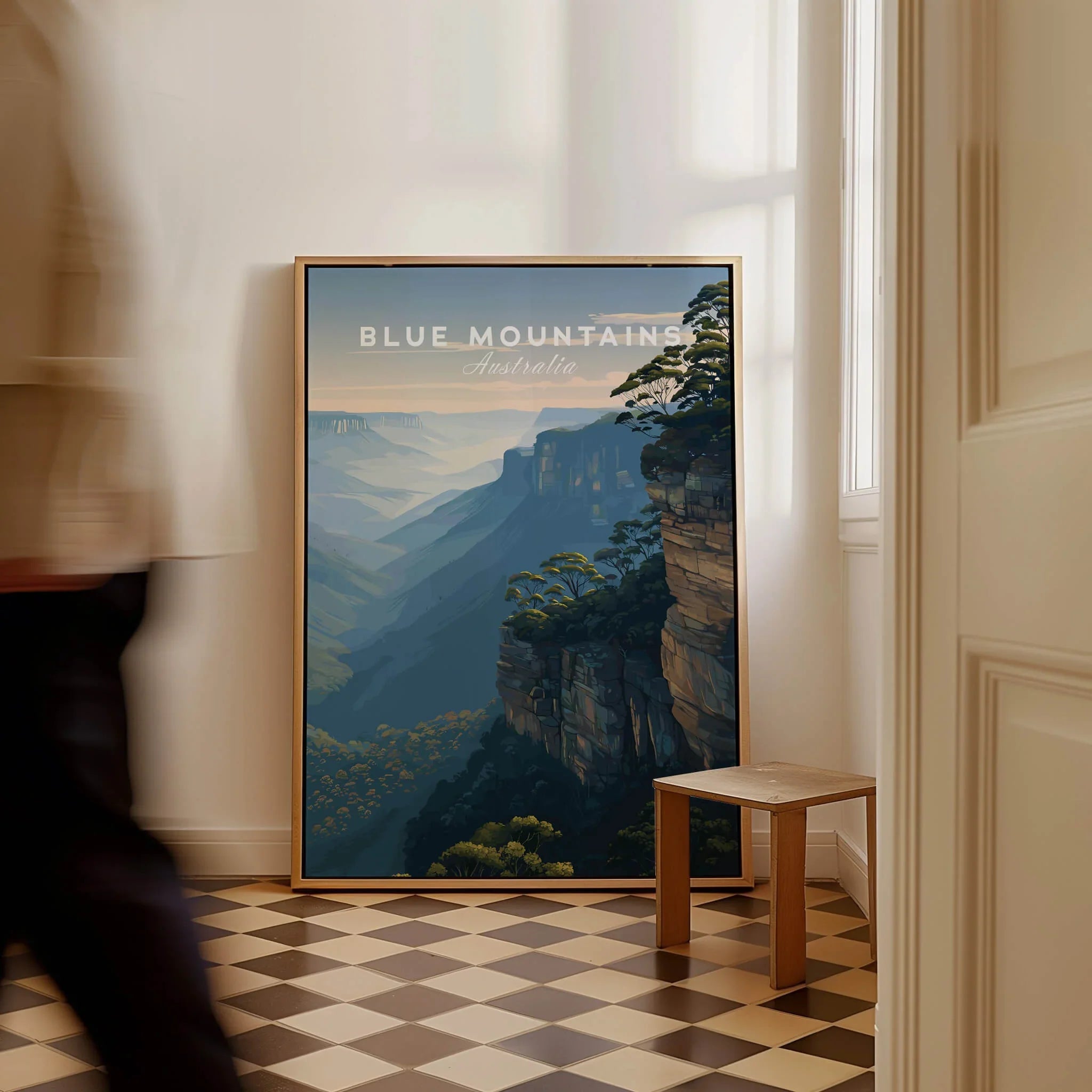 Framed Blue Mountains Australia travel poster on floor in modern hallway, man walking past