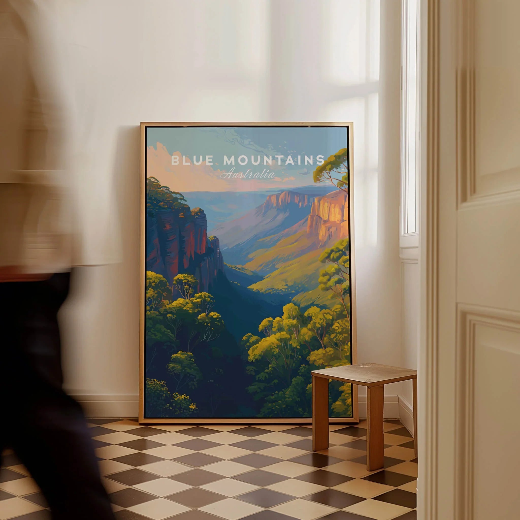 Blue Mountains Australia travel poster framed on floor in bright hallway, person walking by.