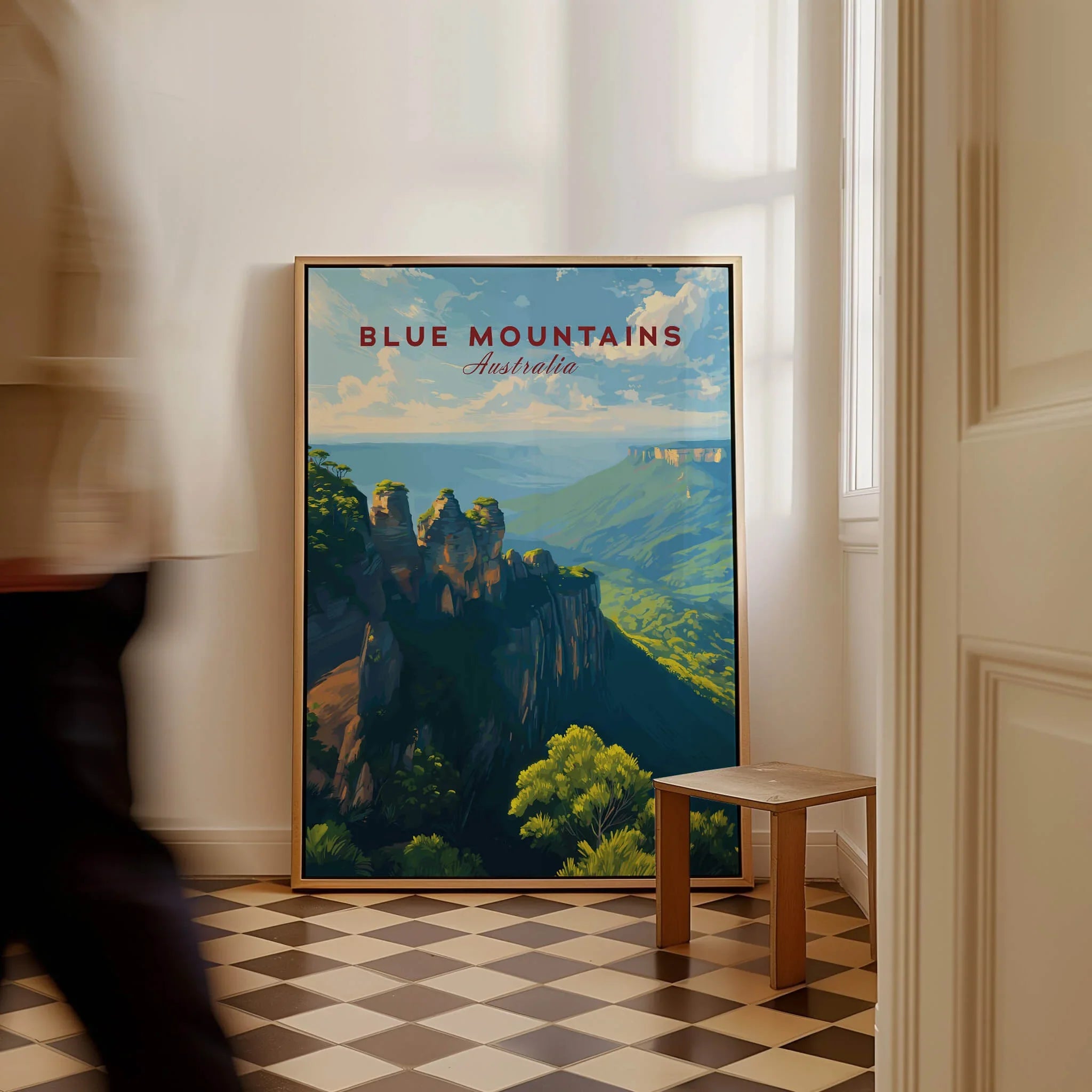 Blue Mountains Australia travel poster framed on floor in bright hallway, man walking past