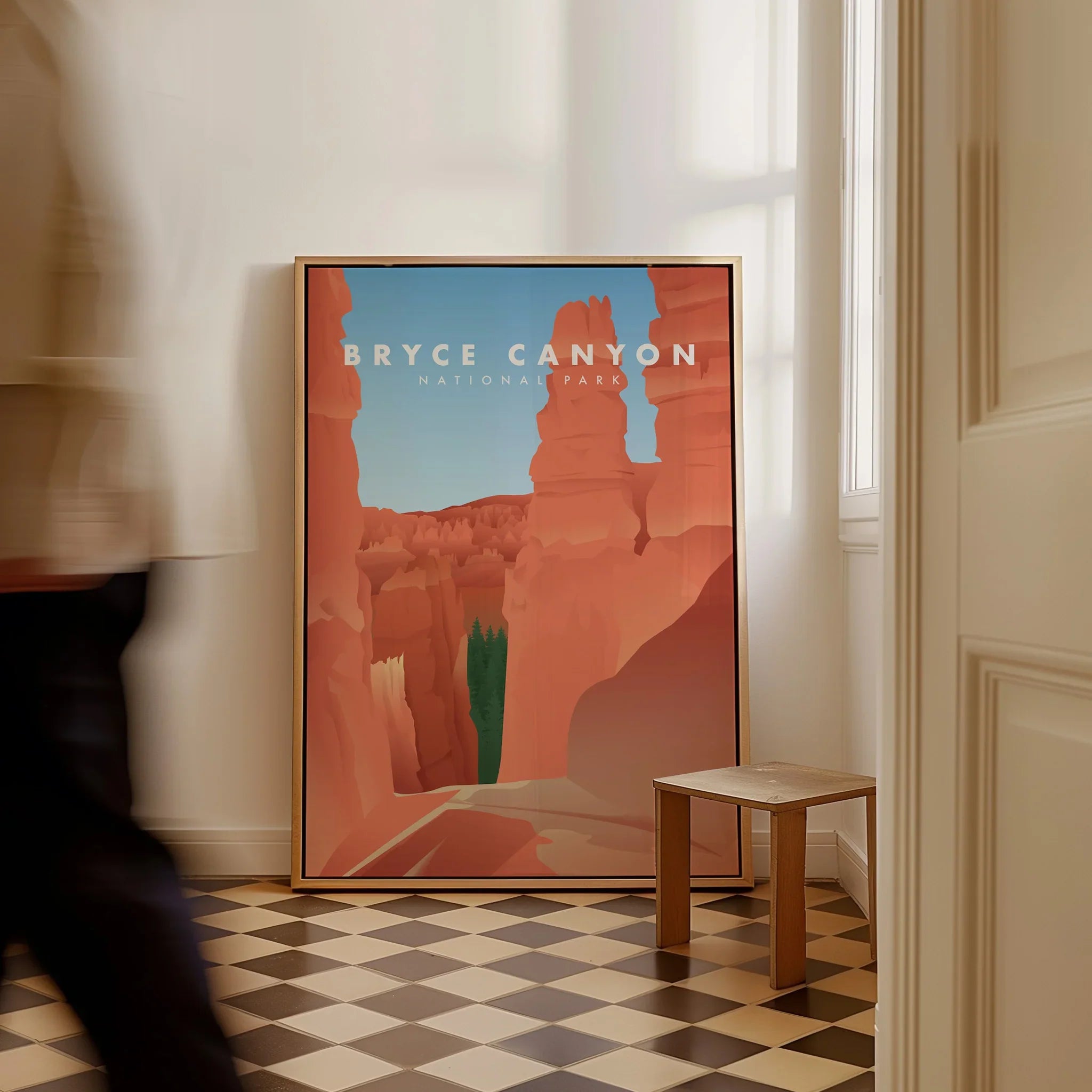 Framed Bryce Canyon National Park travel poster on floor, modern home decor, man walking past