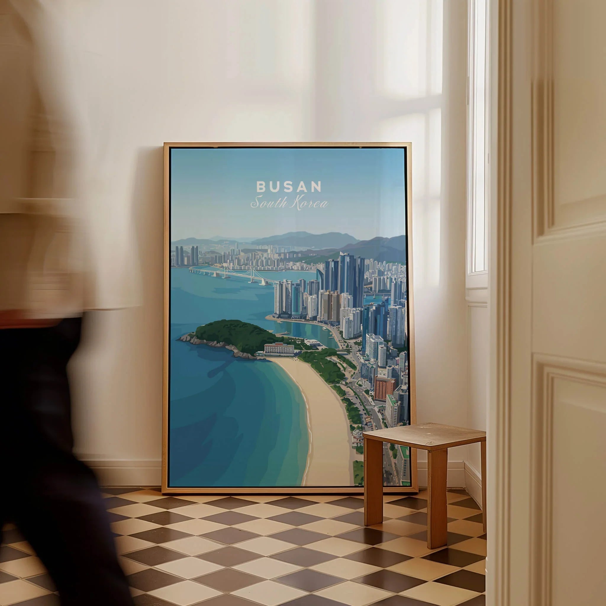 Framed Busan South Korea travel poster with city skyline and beach, leaning on floor