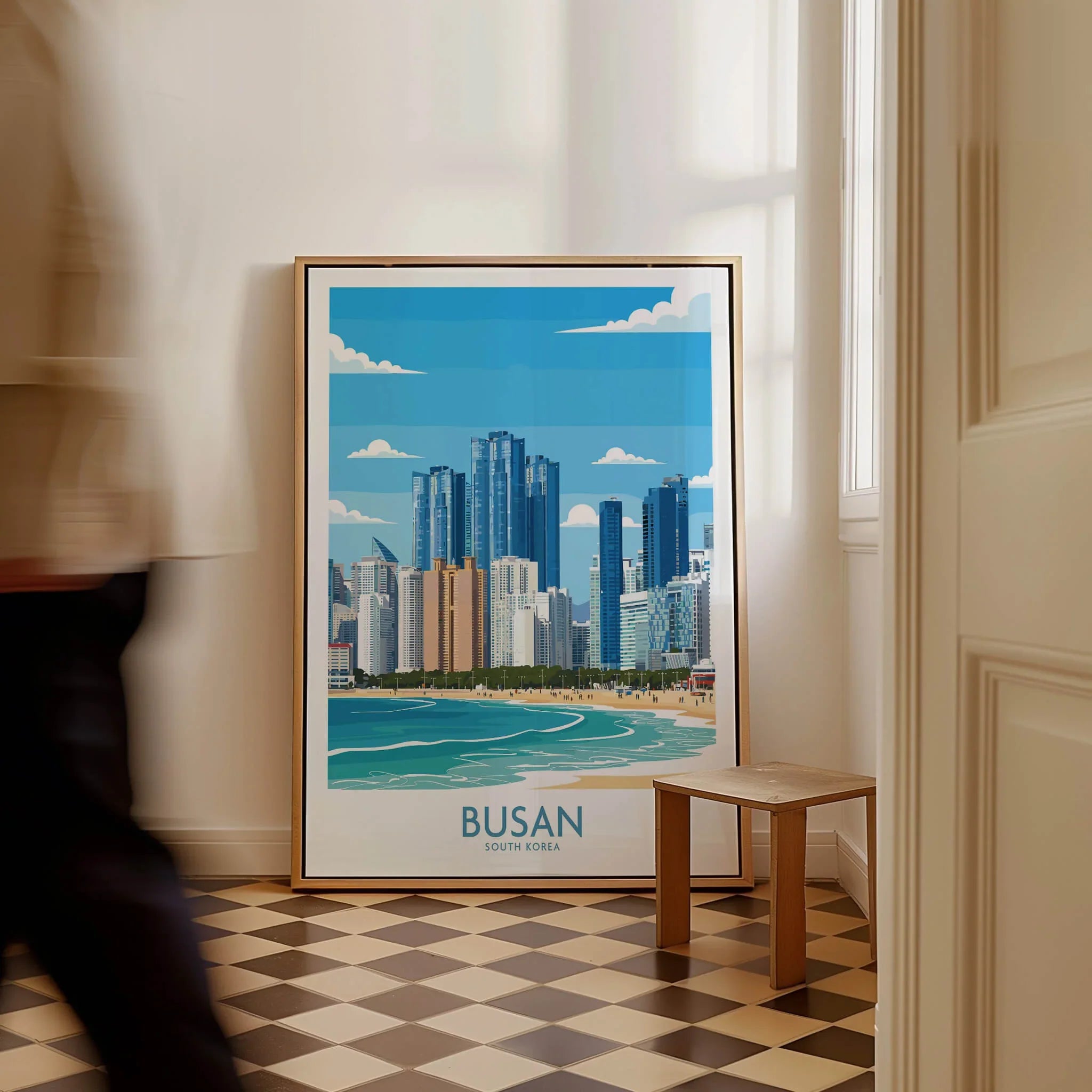 Framed Busan South Korea skyline wall art with man walking past on checkered floor