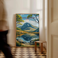 Framed Cadair Idris travel poster with mountain landscape on floor, man walking past.