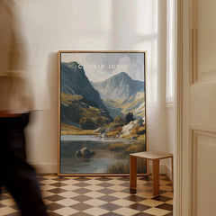 Framed Cadair Idris travel poster with mountain landscape art resting on checkered floor