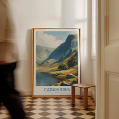 Framed Cadair Idris Wales travel poster on checkered floor, man walking past