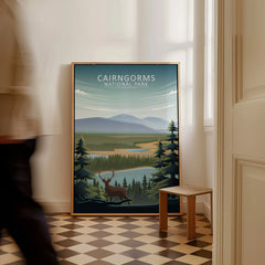 Framed Cairngorms National Park travel poster with landscape and stag illustration on floor