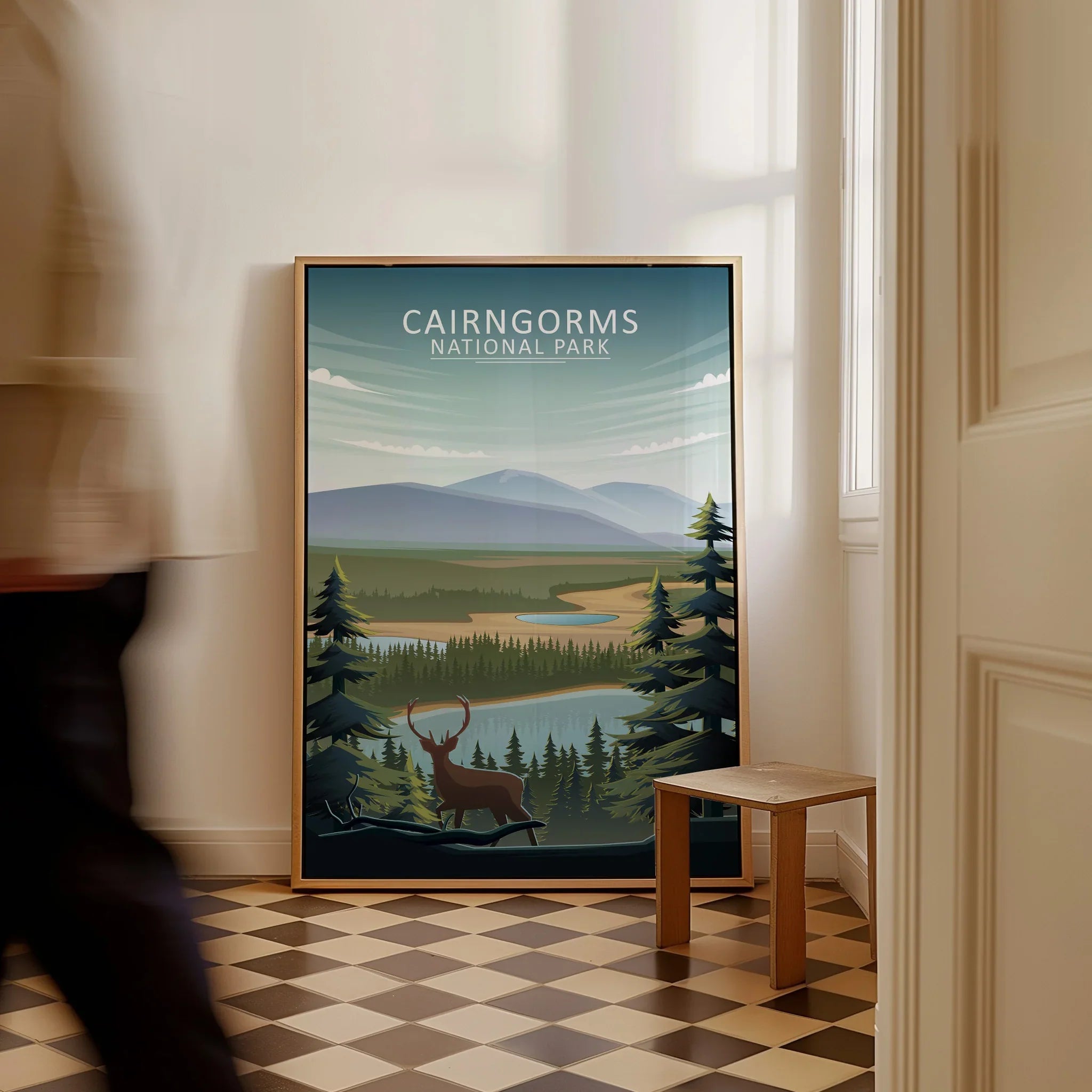 Framed Cairngorms National Park travel poster with landscape and stag illustration on floor