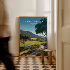 Framed Carmel Valley California travel poster with scenic landscape on checkered floor by window