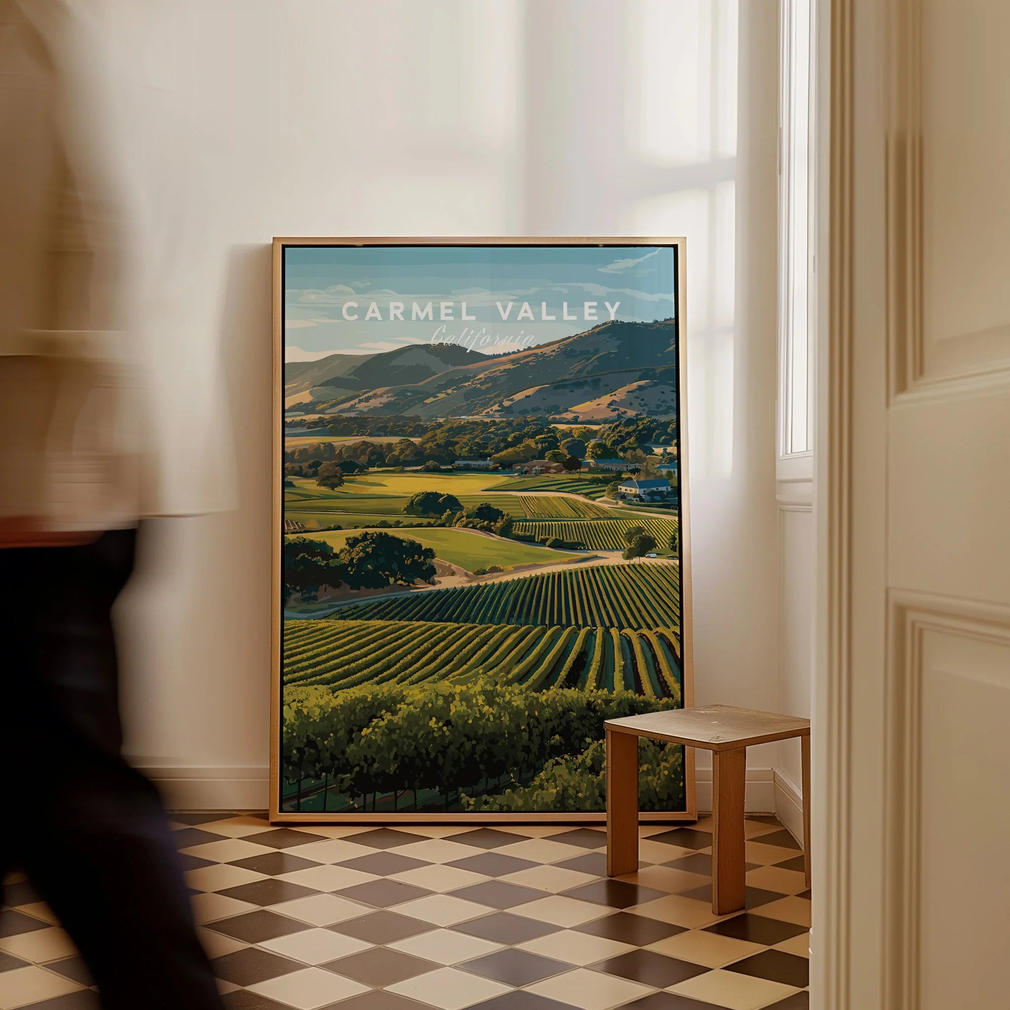 Framed Carmel Valley California travel poster on floor in sunlit home interior