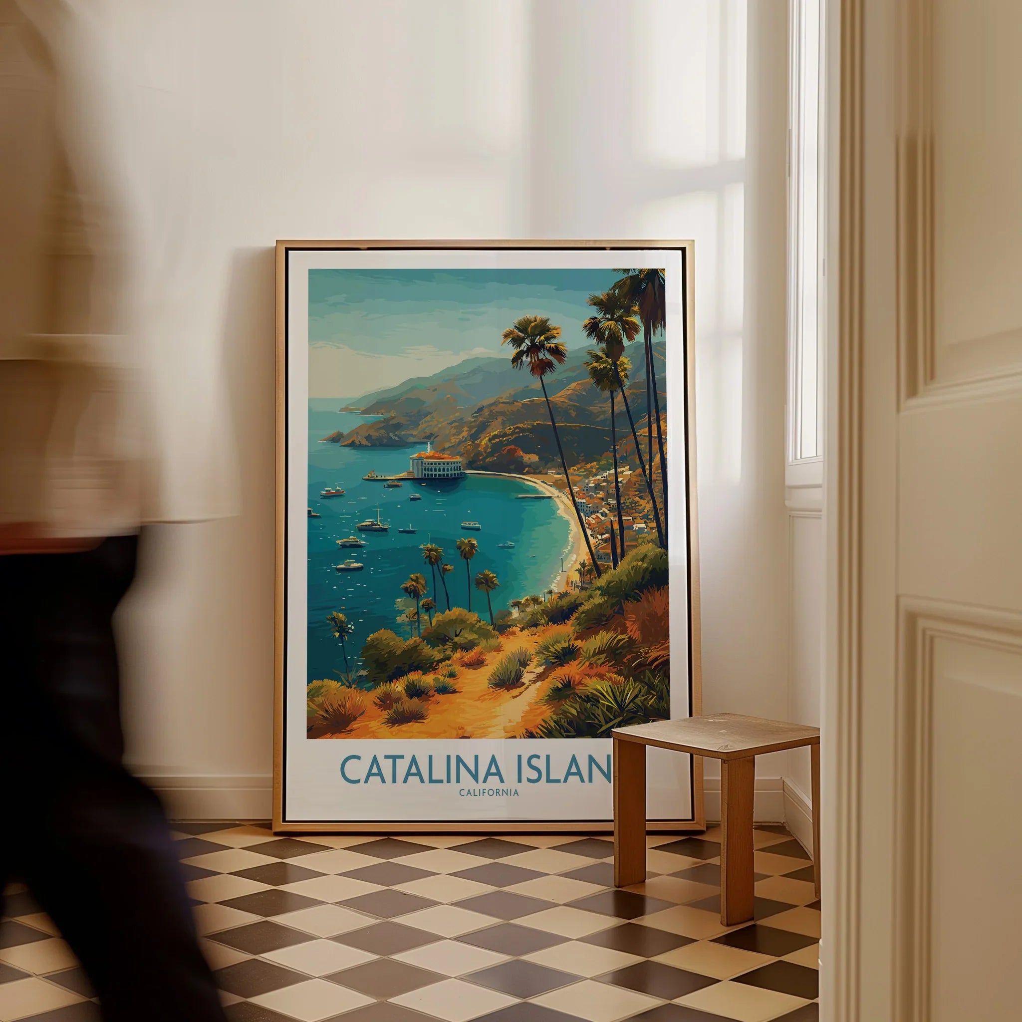 Framed Catalina Island travel poster with coastal landscape on floor in bright hallway