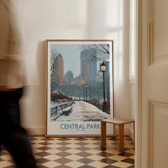 Framed Central Park New York wall art print with snowy city skyline, leaning on floor.