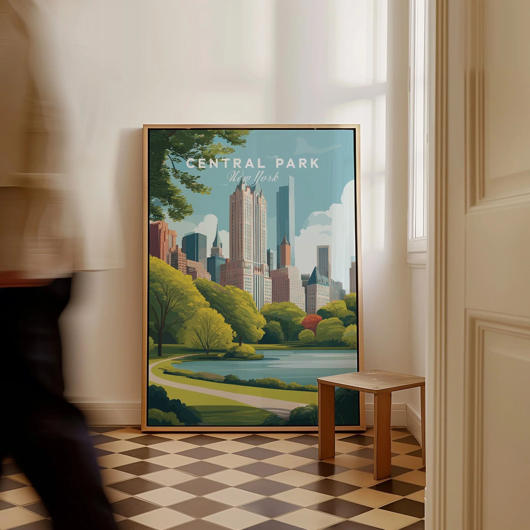 Framed Central Park New York travel poster with city skyline, resting on a checkered floor.