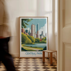 Framed Central Park New York travel poster with city skyline art on floor near a stool