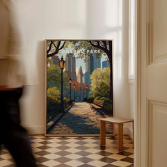 Framed Central Park city skyline wall art on floor with man walking past in bright room