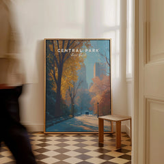 Framed Central Park New York travel poster with autumn trees leaning against a wall indoors.