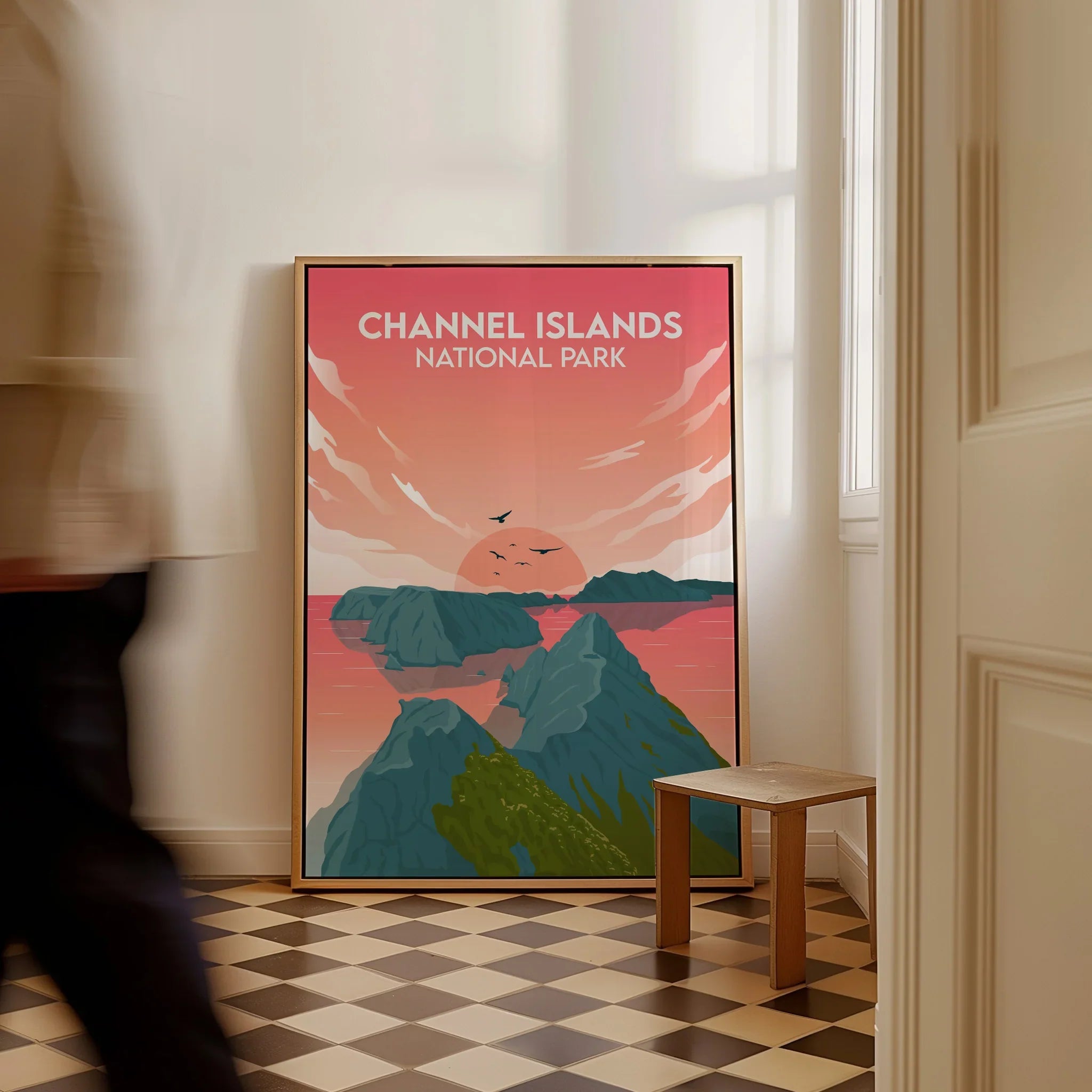 Framed Channel Islands National Park travel poster with sunset and ocean, leaning on floor.