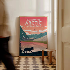 Framed Gates of the Arctic National Park poster with wolf and mountains on floor indoors