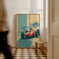 Framed vintage race car art print on floor, man walking by, home interior decor