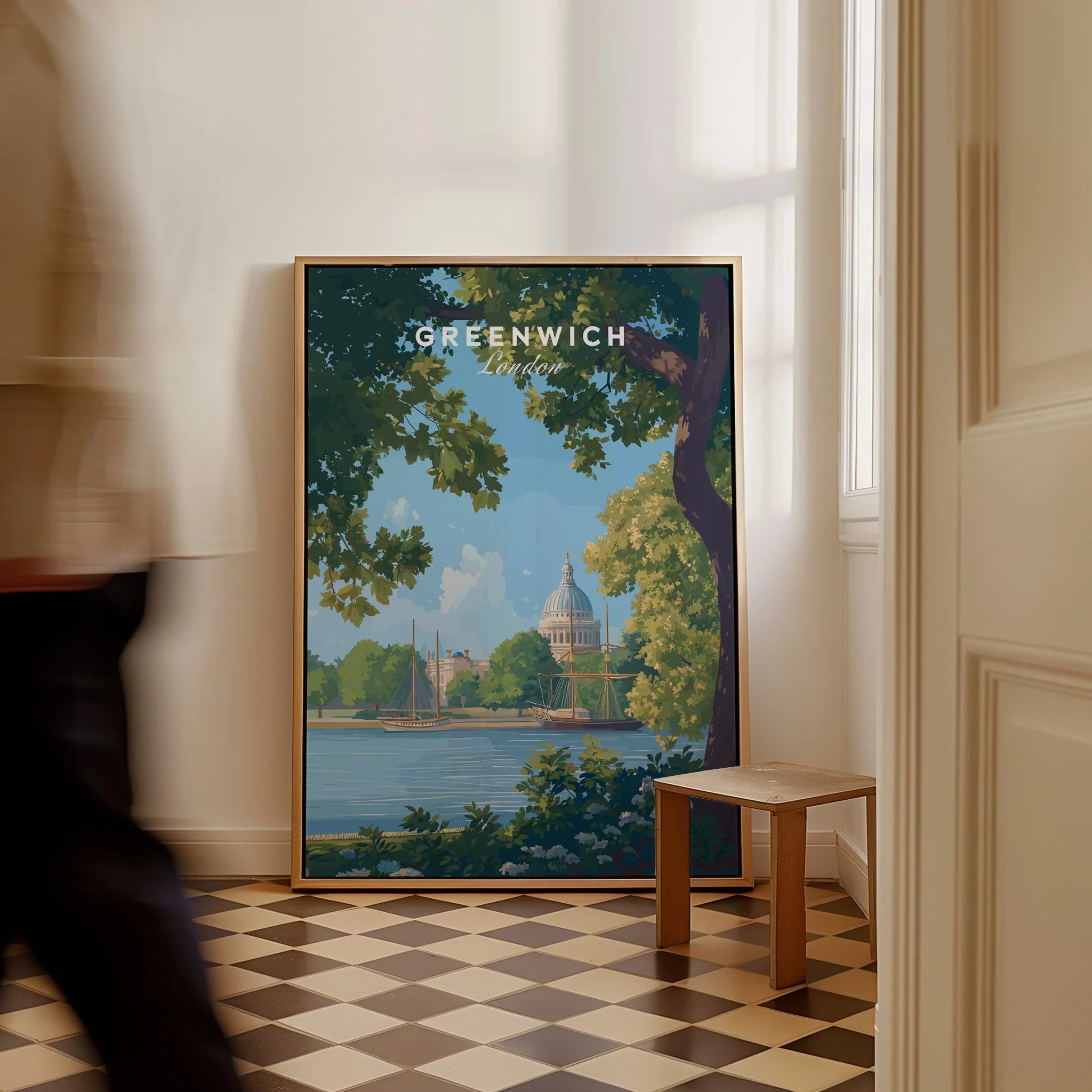 Greenwich London travel poster framed on floor in modern entryway, man walking past