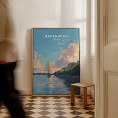 Framed Greenwich London travel poster leaning on wall with a person walking past