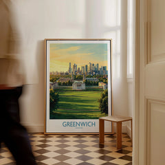 Framed Greenwich London city skyline travel poster on floor in bright hallway, man walking past.