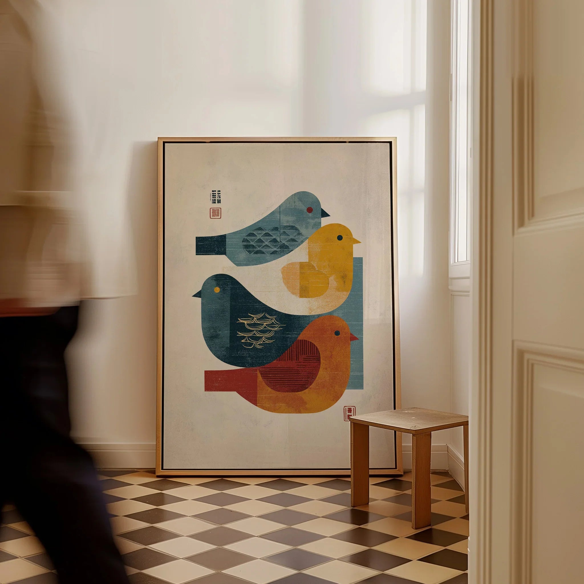 Framed minimalist art print of colorful birds on floor in bright modern hallway