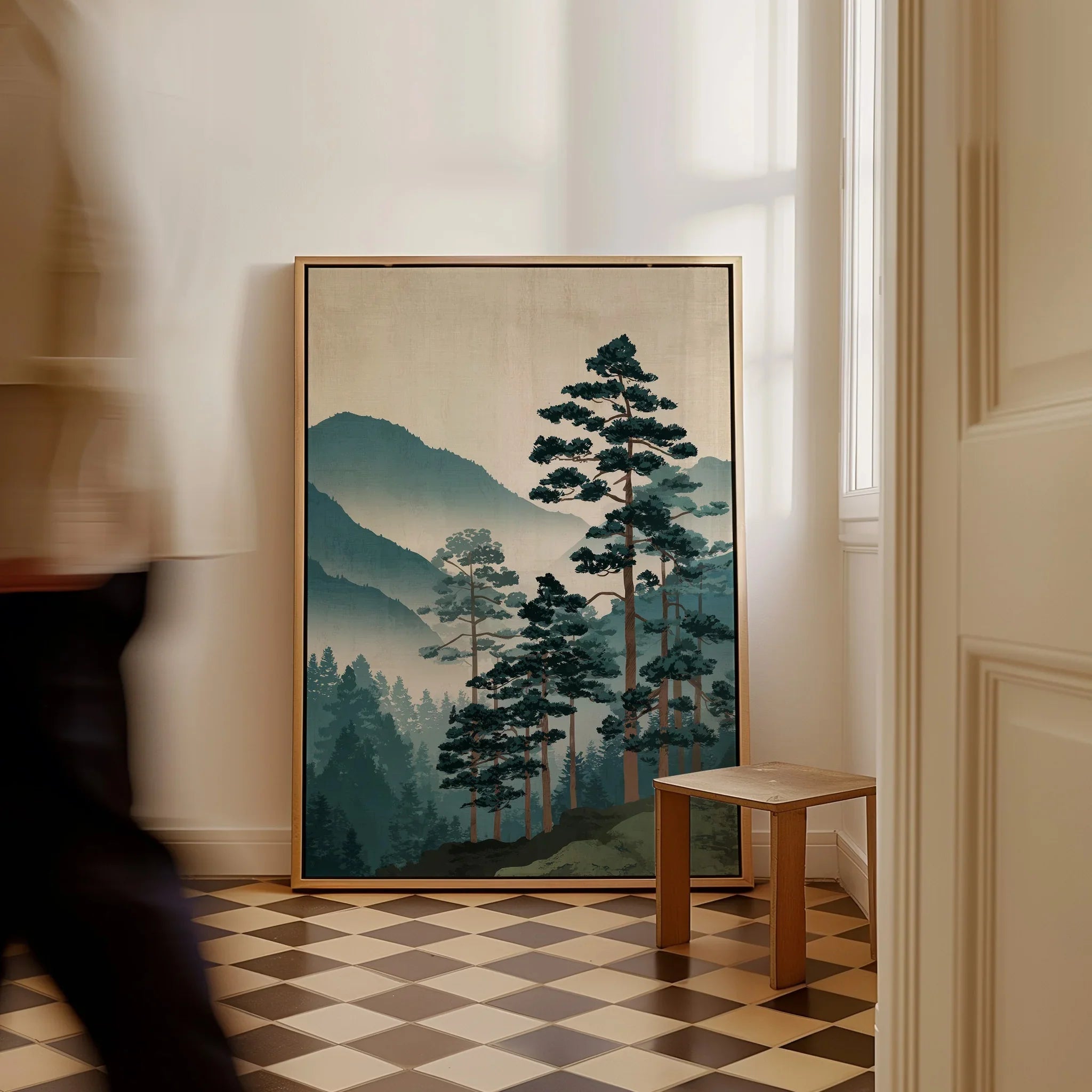 Framed Japanese woodblock-style landscape art with misty mountains and pine trees on a tiled floor.