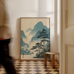 Framed Japanese woodblock landscape art on floor, man walking past in modern home