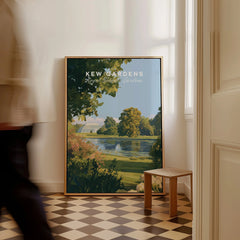 Framed Kew Gardens travel art print on floor in bright hallway, person walking past