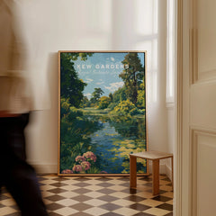 Framed Kew Gardens travel poster print on checkered floor in modern home interior