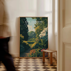 Framed Kew Gardens travel poster on a checkered floor with a man walking past