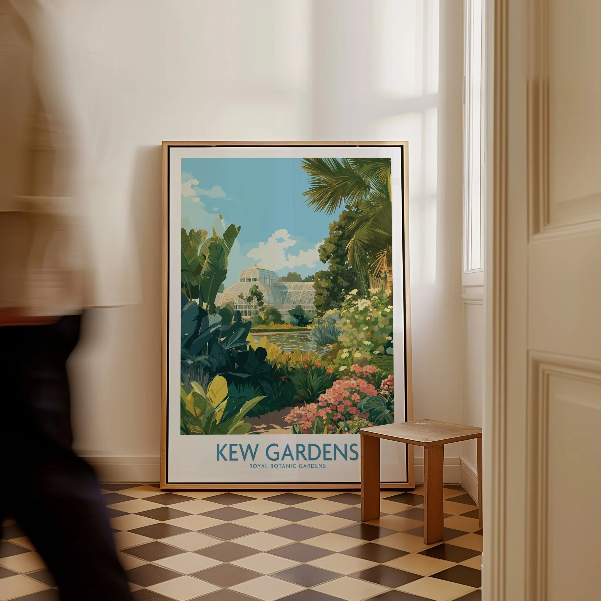 Framed Kew Gardens travel poster with botanical art leaning on wall in bright hallway