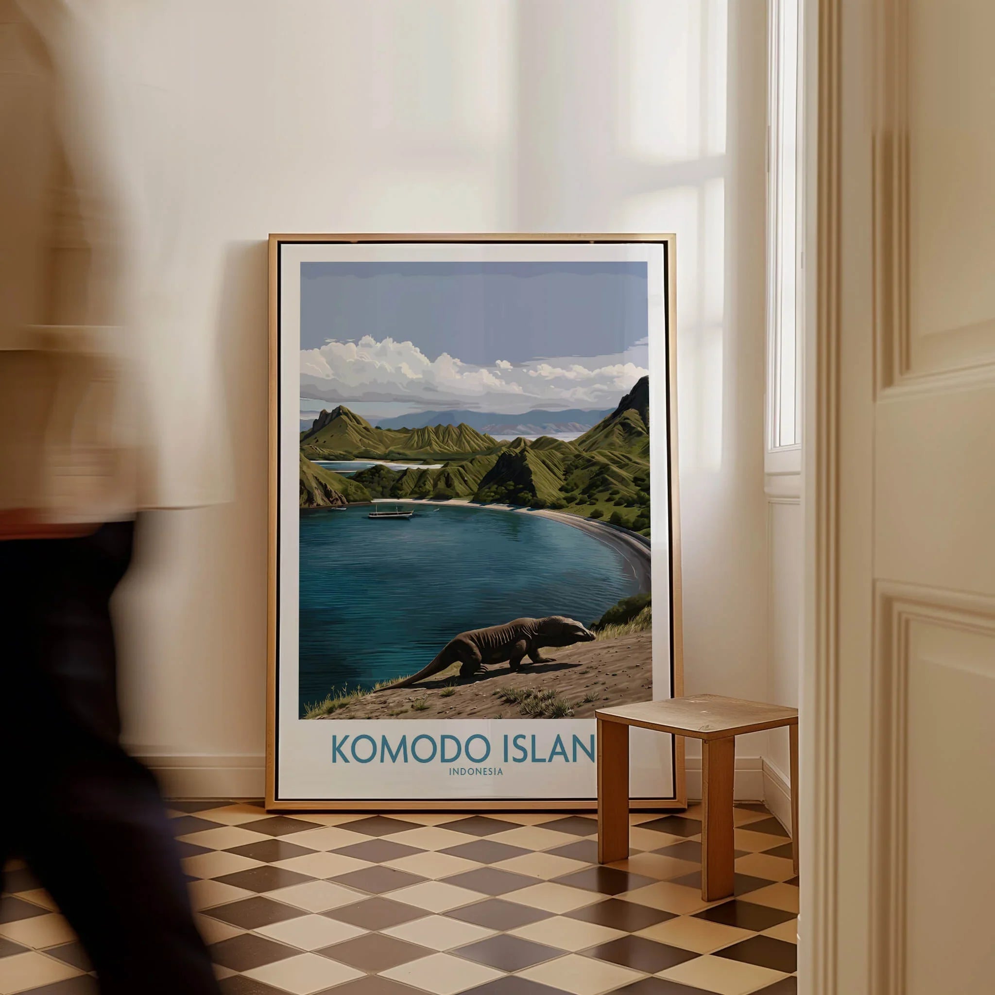 Framed Komodo Island travel poster on floor, featuring landscape and Komodo dragon artwork.