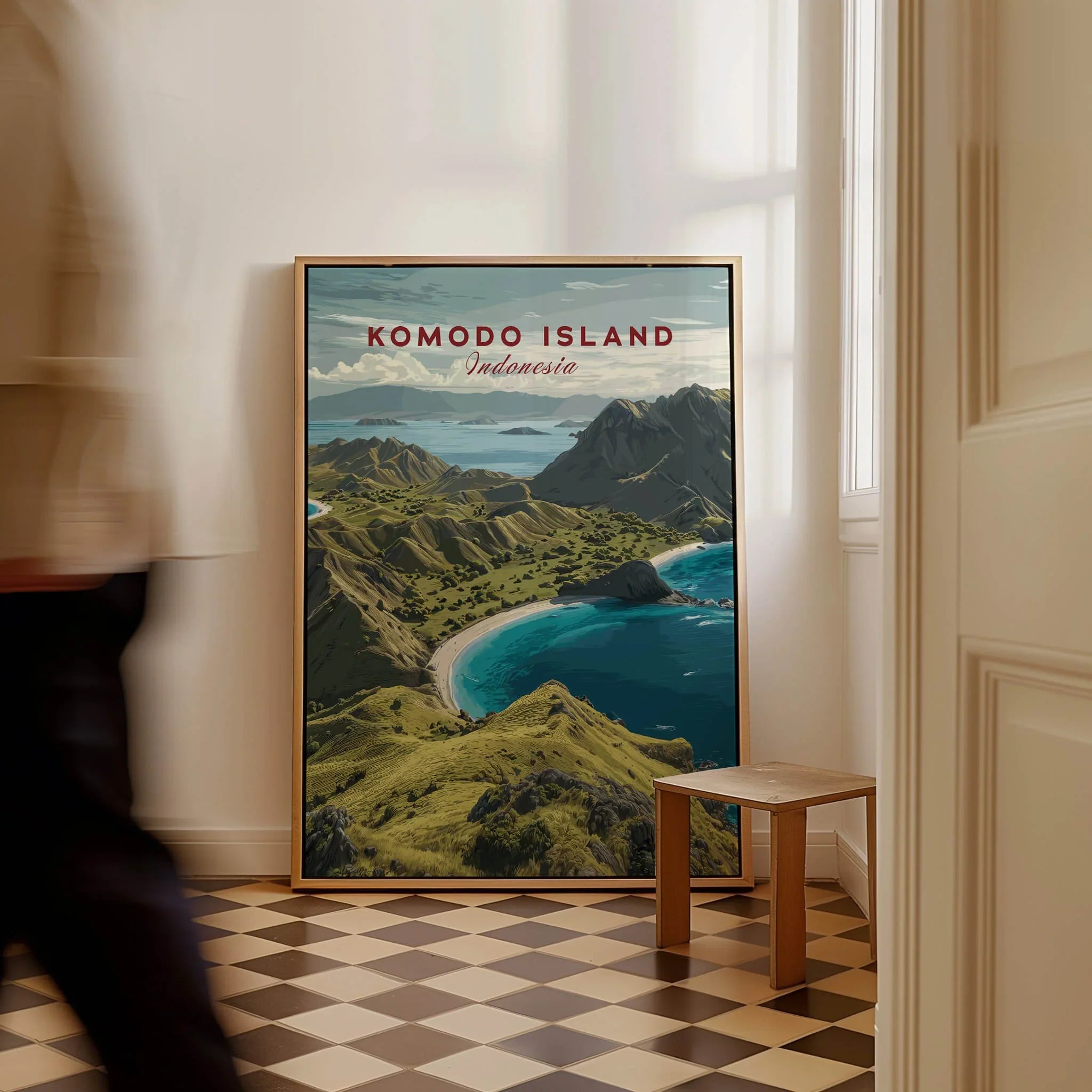 Komodo Island Indonesia travel poster framed on floor in sunlit hallway, man walking past