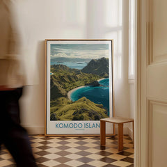 Framed Komodo Island travel poster leaning on wall in bright hallway with checkerboard floor.