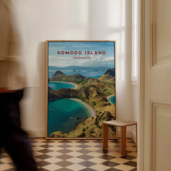Framed Komodo Island travel poster print on floor in bright modern room, man walking past