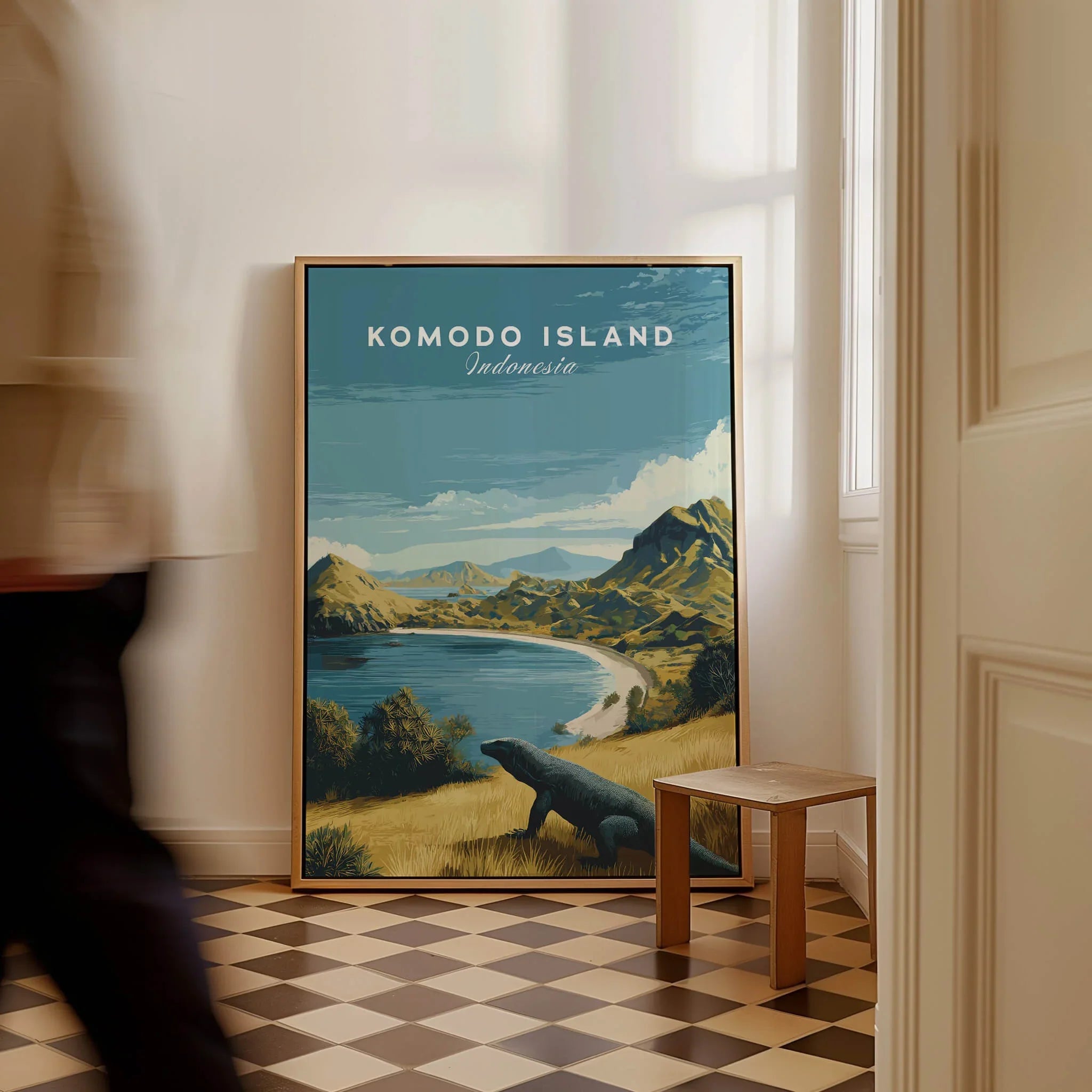 Framed Komodo Island Indonesia travel poster with landscape art on floor, person walking past