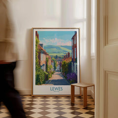 Framed Lewes England travel poster with scenic street art on floor in bright hallway