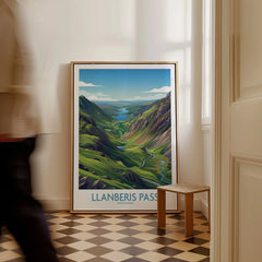 Framed Llanberis Pass Snowdonia travel poster on floor with man walking past